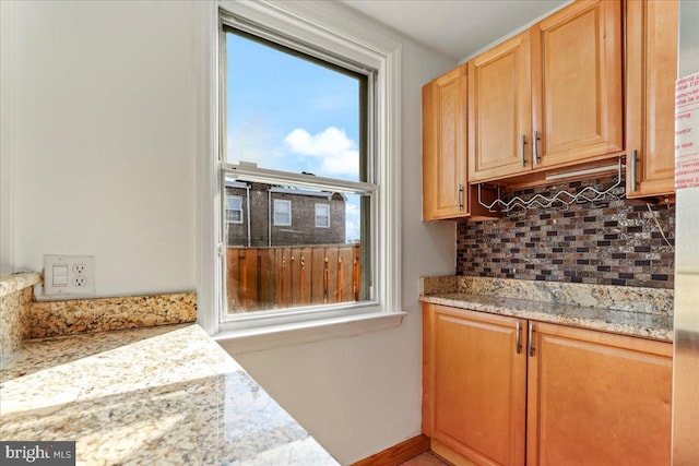 kitchen featuring light stone counters and decorative backsplash