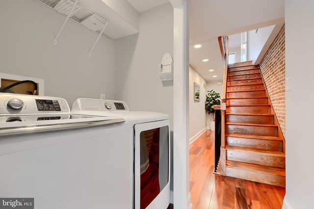 laundry area featuring light wood-type flooring, laundry area, recessed lighting, and washing machine and clothes dryer