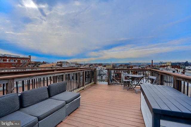 deck featuring an outdoor hangout area and a view of city