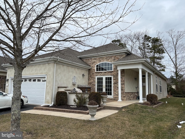 view of front of property with a front yard and a garage