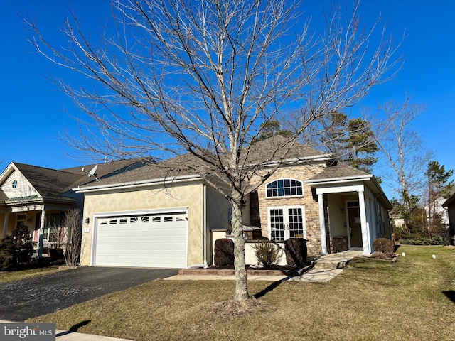 view of front of property with a garage and a front lawn