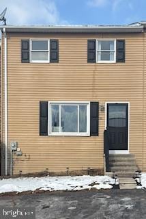 view of snow covered rear of property