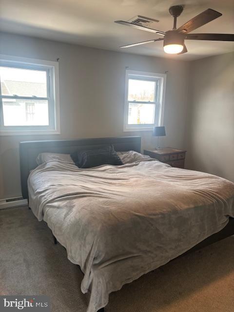 carpeted bedroom with ceiling fan