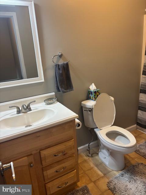 bathroom with vanity, tile patterned floors, and toilet