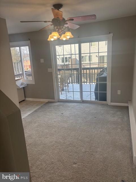 unfurnished room with ceiling fan and carpet