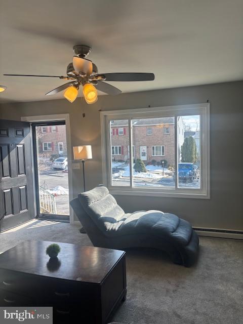 interior space with ceiling fan and baseboard heating