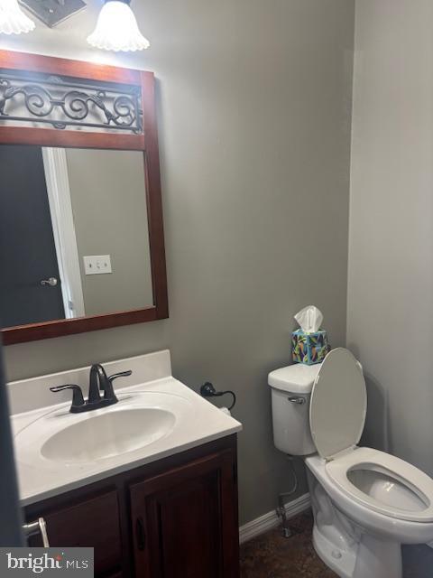 bathroom featuring vanity and toilet