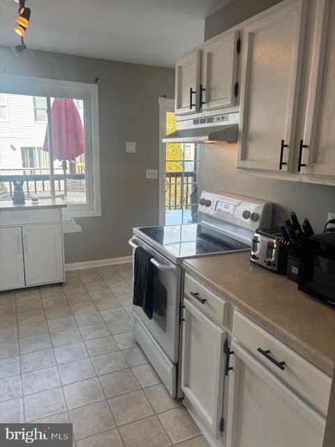 kitchen with white cabinets and white range with electric stovetop