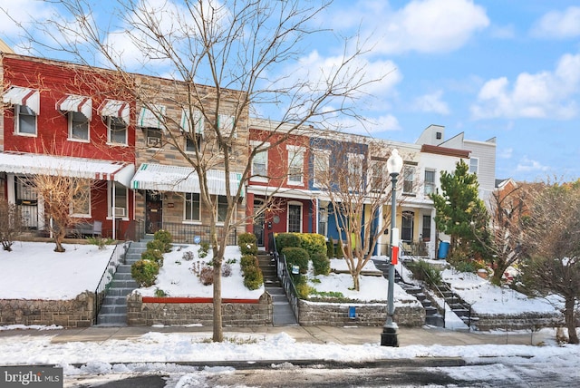 townhome / multi-family property with a porch