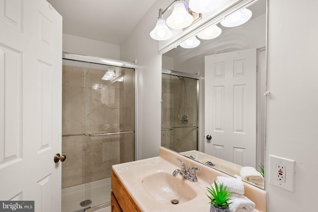 bathroom with an enclosed shower and vanity