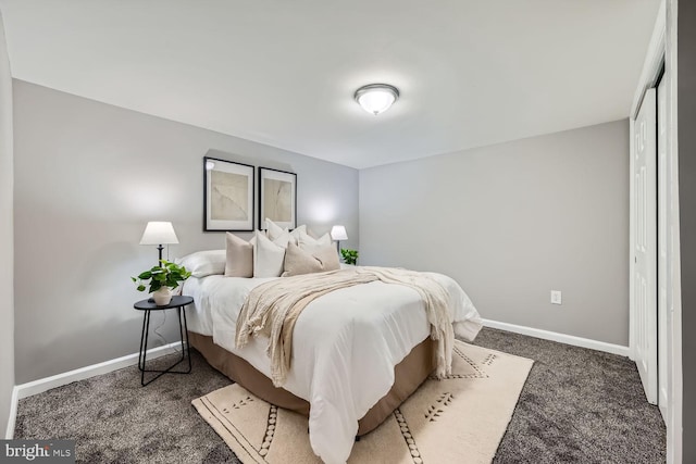 bedroom with dark colored carpet