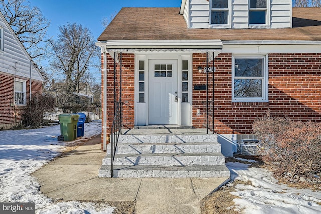 view of snow covered property entrance