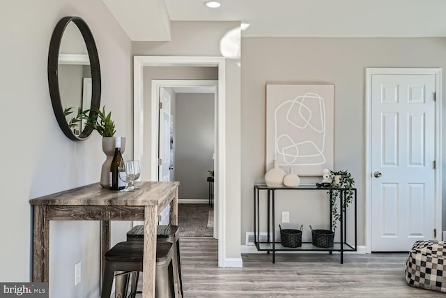 hallway with hardwood / wood-style floors