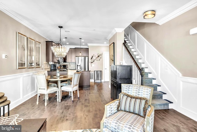 dining area featuring crown molding, a notable chandelier, and dark hardwood / wood-style flooring