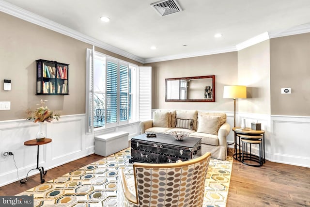 living room featuring ornamental molding and wood-type flooring