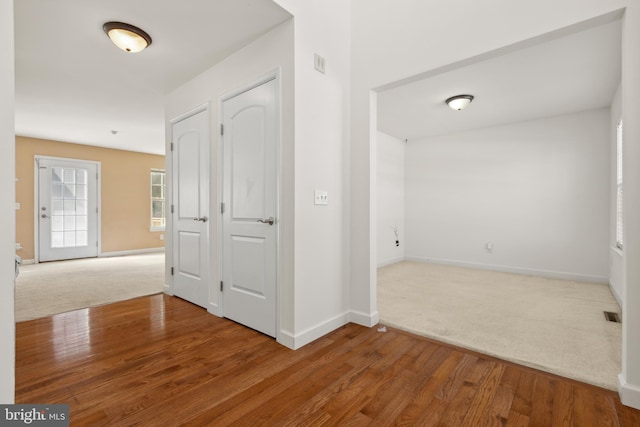 corridor with wood-type flooring