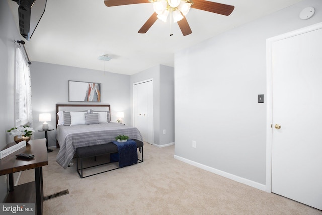 bedroom featuring light carpet, ceiling fan, and a closet