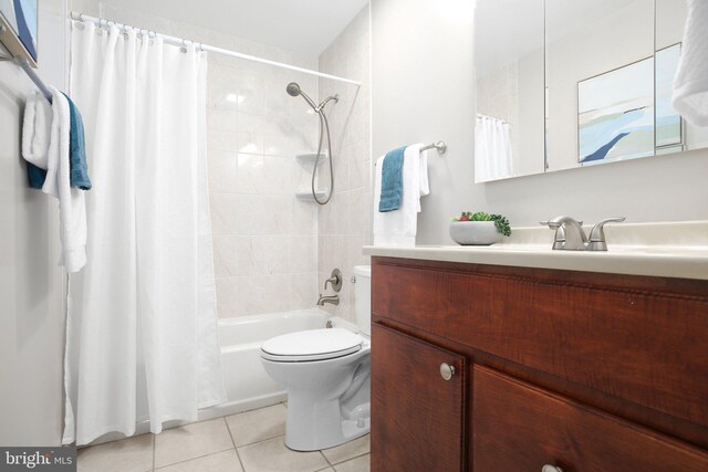 full bathroom featuring shower / bathtub combination with curtain, vanity, tile patterned flooring, and toilet