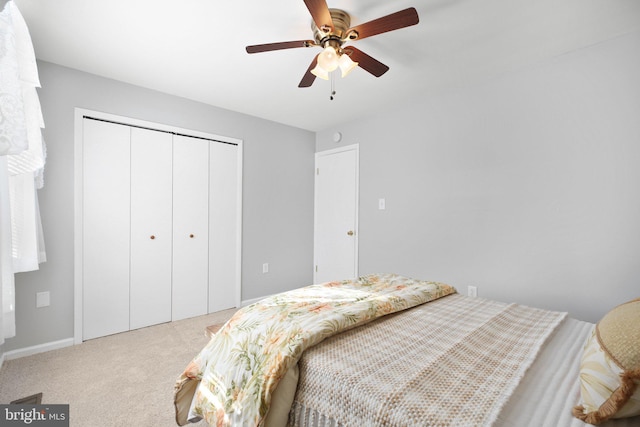 carpeted bedroom with a closet and ceiling fan