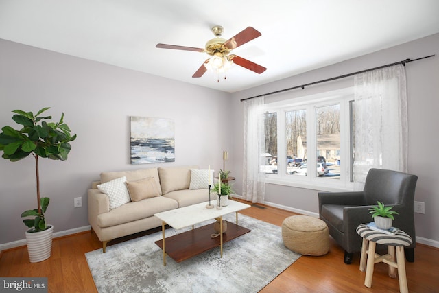 living room featuring hardwood / wood-style floors and ceiling fan