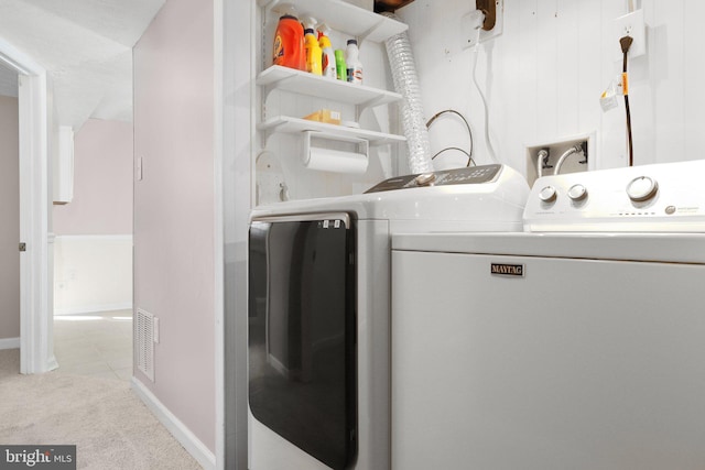 laundry room featuring light colored carpet and washing machine and clothes dryer