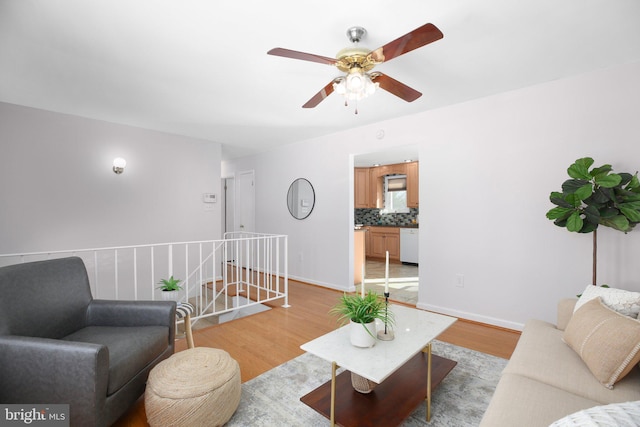 living room featuring ceiling fan and light wood-type flooring