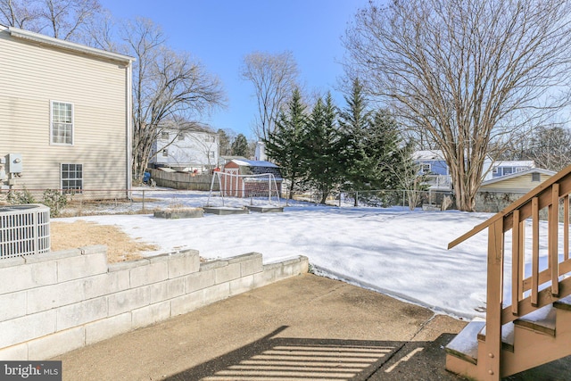 snowy yard with central air condition unit