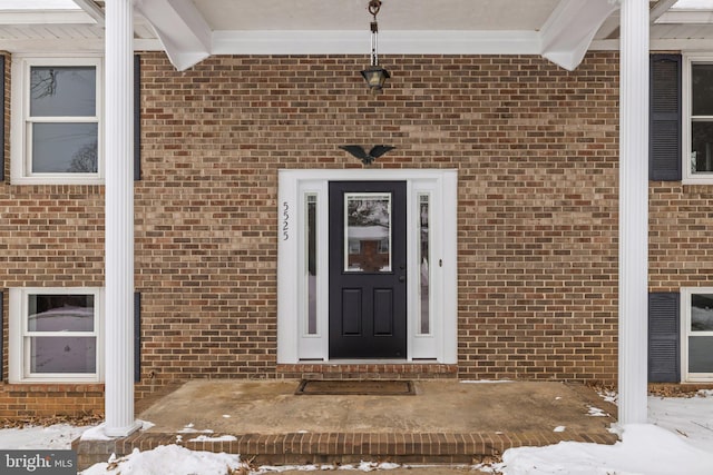 view of snow covered property entrance