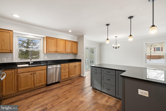 kitchen with dishwasher, sink, dark wood-type flooring, hanging light fixtures, and crown molding