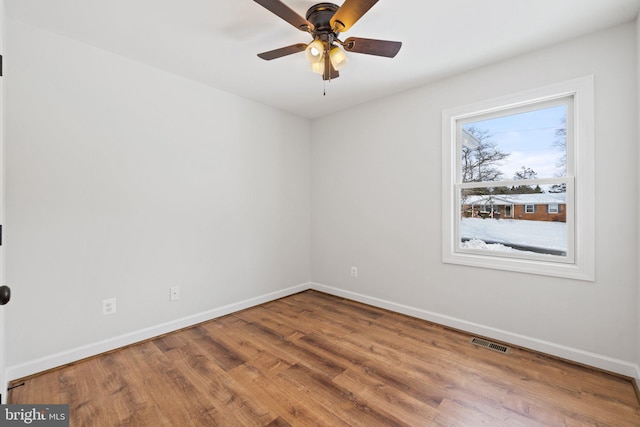 unfurnished room featuring ceiling fan, a healthy amount of sunlight, and wood-type flooring