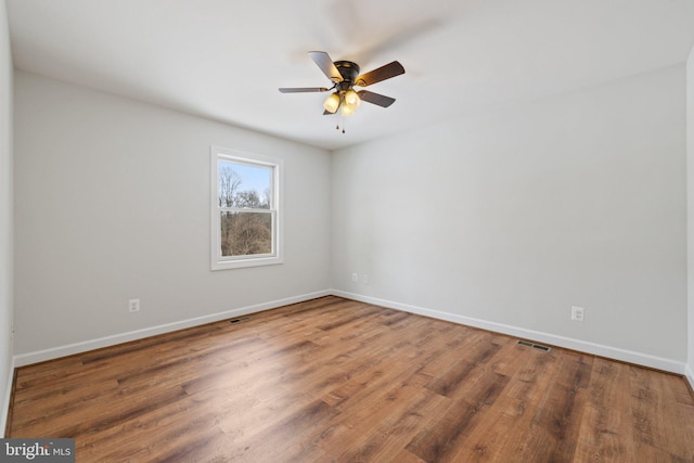 spare room featuring hardwood / wood-style floors and ceiling fan