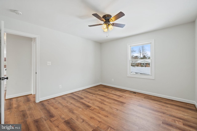 spare room with hardwood / wood-style floors and ceiling fan