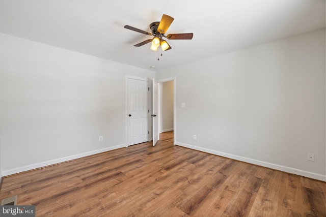 empty room featuring hardwood / wood-style floors and ceiling fan