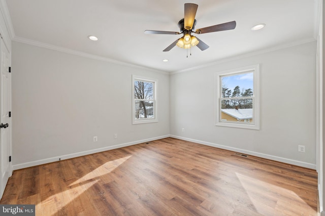 spare room with ceiling fan, ornamental molding, and light hardwood / wood-style flooring