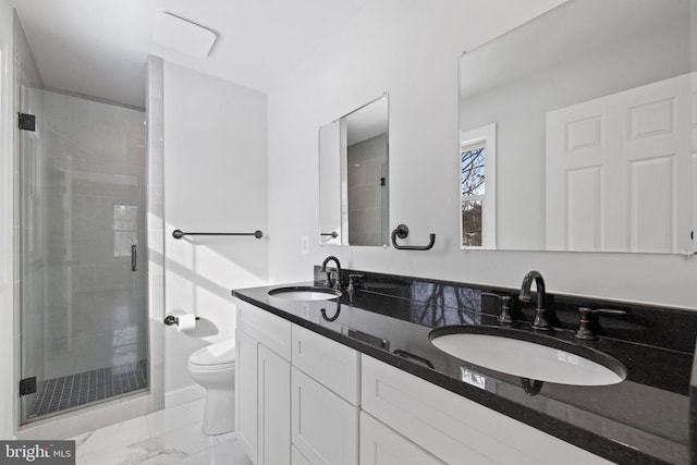 bathroom with vanity, toilet, and a shower with shower door