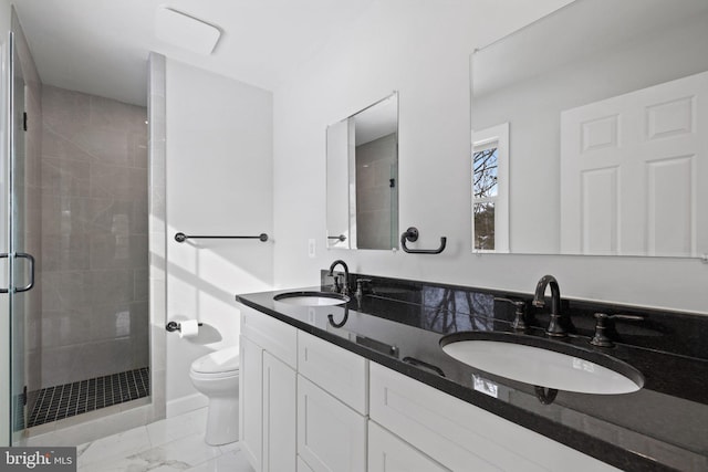 bathroom featuring vanity, an enclosed shower, and toilet