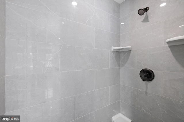 bathroom with tiled shower