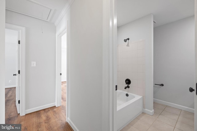 bathroom with tile patterned flooring and tiled shower / bath combo