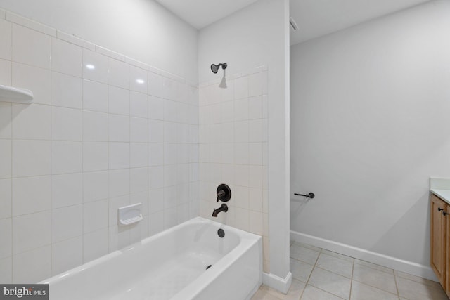 bathroom featuring tile patterned flooring, vanity, and tiled shower / bath