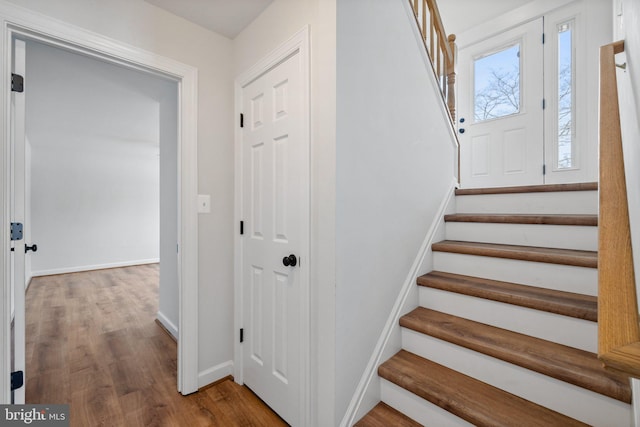 staircase with wood-type flooring