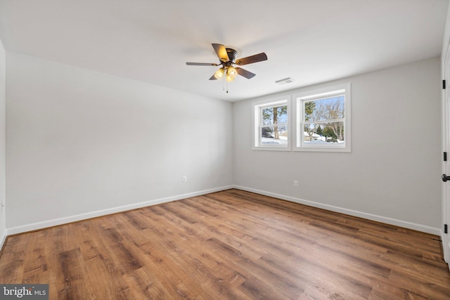 empty room featuring ceiling fan and wood-type flooring