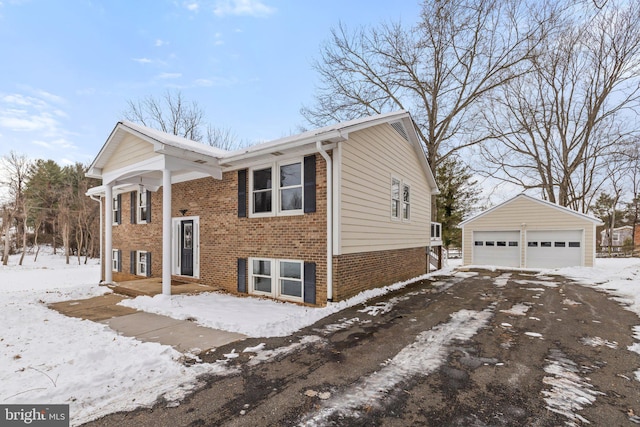 split foyer home featuring a garage and an outbuilding