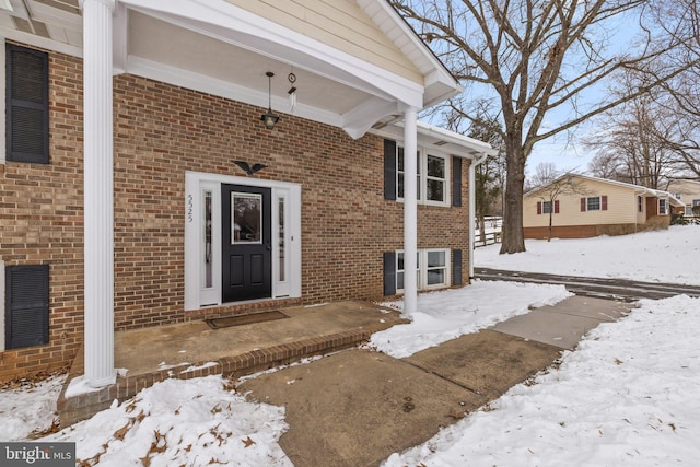 view of snow covered property entrance