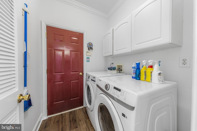 laundry area featuring cabinets, dark hardwood / wood-style flooring, washing machine and dryer, and crown molding