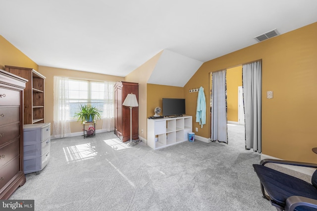 living room with light colored carpet and vaulted ceiling