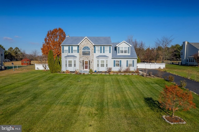 colonial inspired home with a front yard