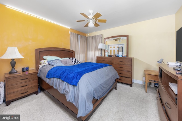 bedroom featuring ceiling fan and light carpet