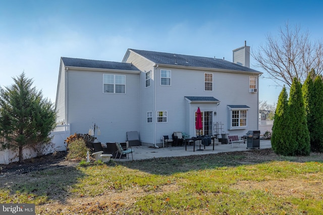 back of house featuring a yard and a patio