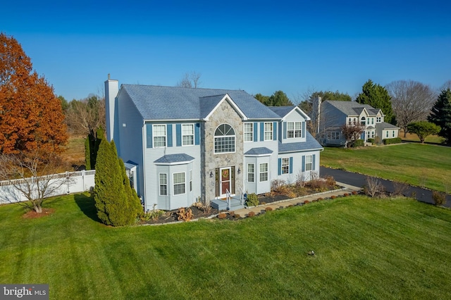 colonial inspired home featuring a front yard