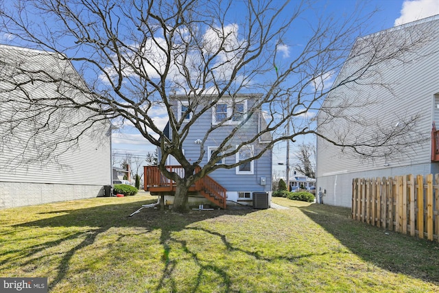 view of yard with central AC, stairway, fence, and a wooden deck